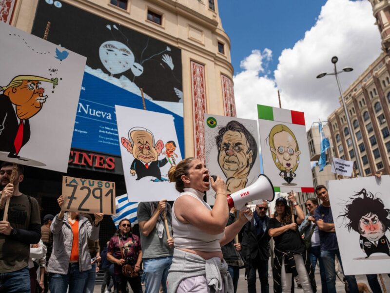 photo of a protest with a woman with a bullhorn