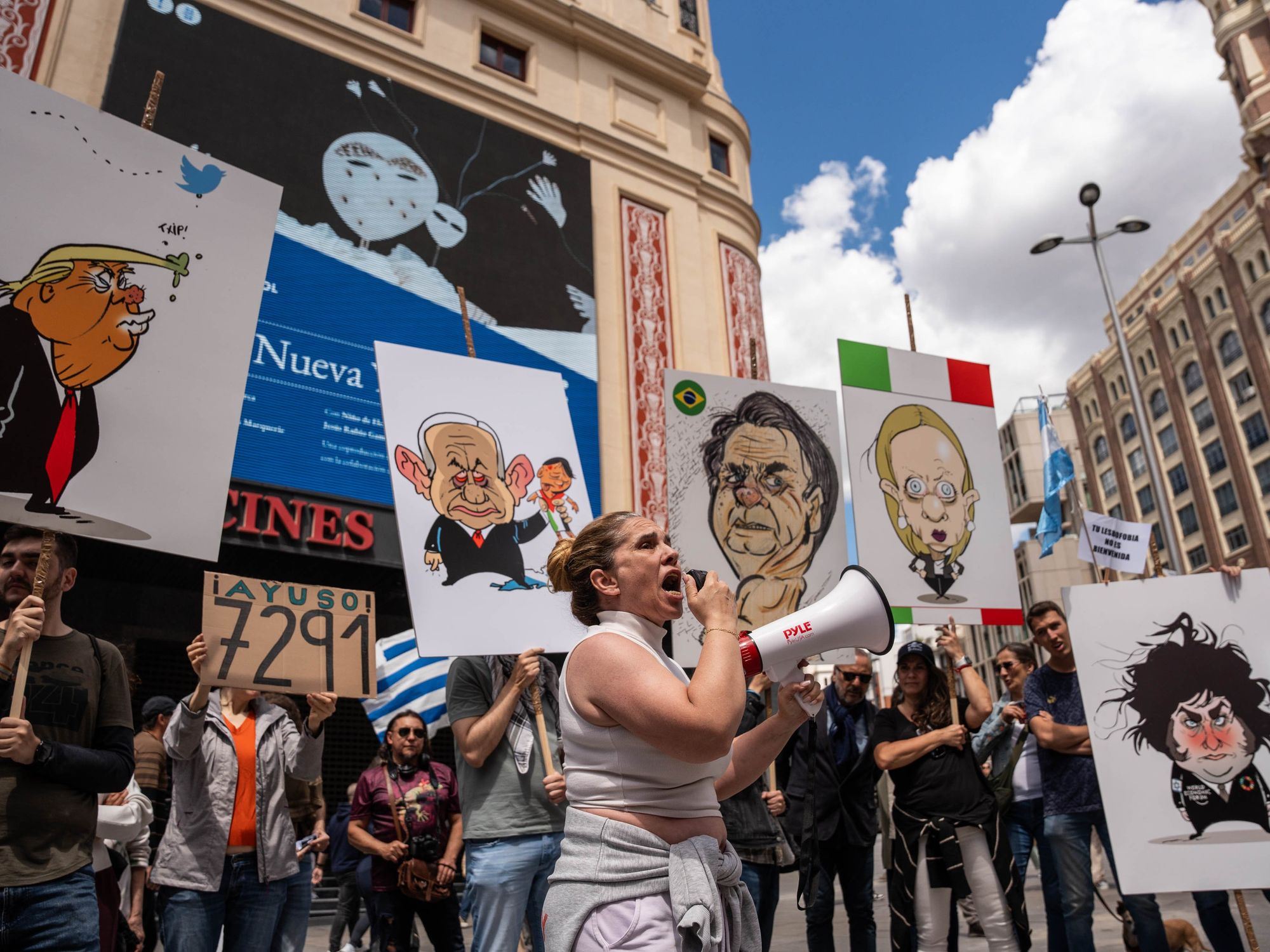 photo of a protest with a woman with a bullhorn