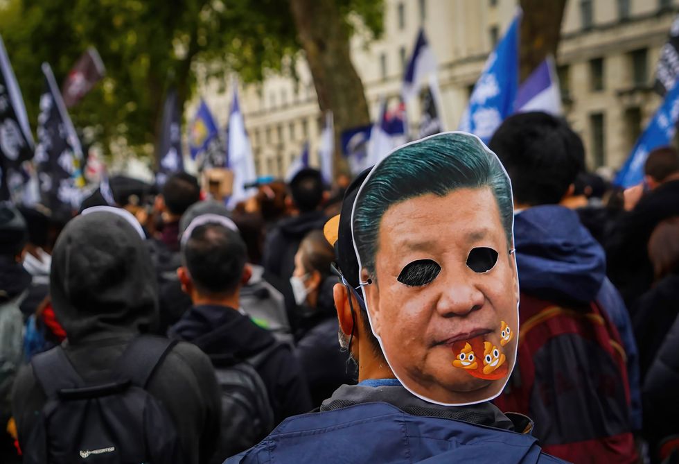 Photo of a protester wearing a Xi Jinping mask during an anti-Chinese Communist Party assembly.
