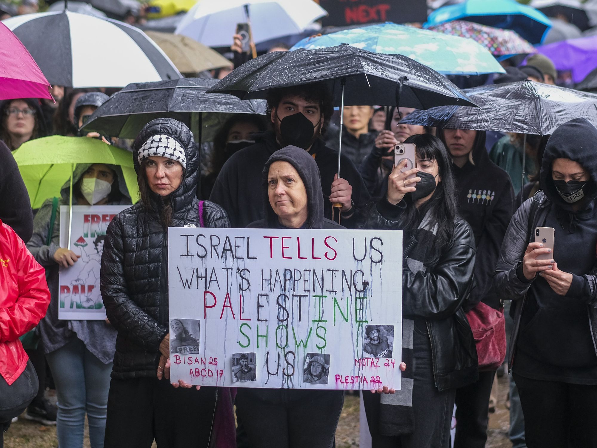 Photo of a protestor holding up a sign during a rally demanding a cease-fire in the Israel-Hamas war