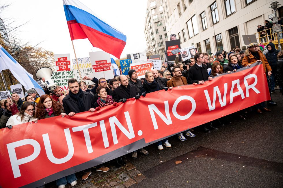 photo of a rally anti war and banner and flags.