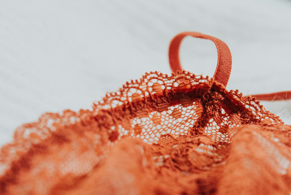 Photo of a red bra thrown on the floor