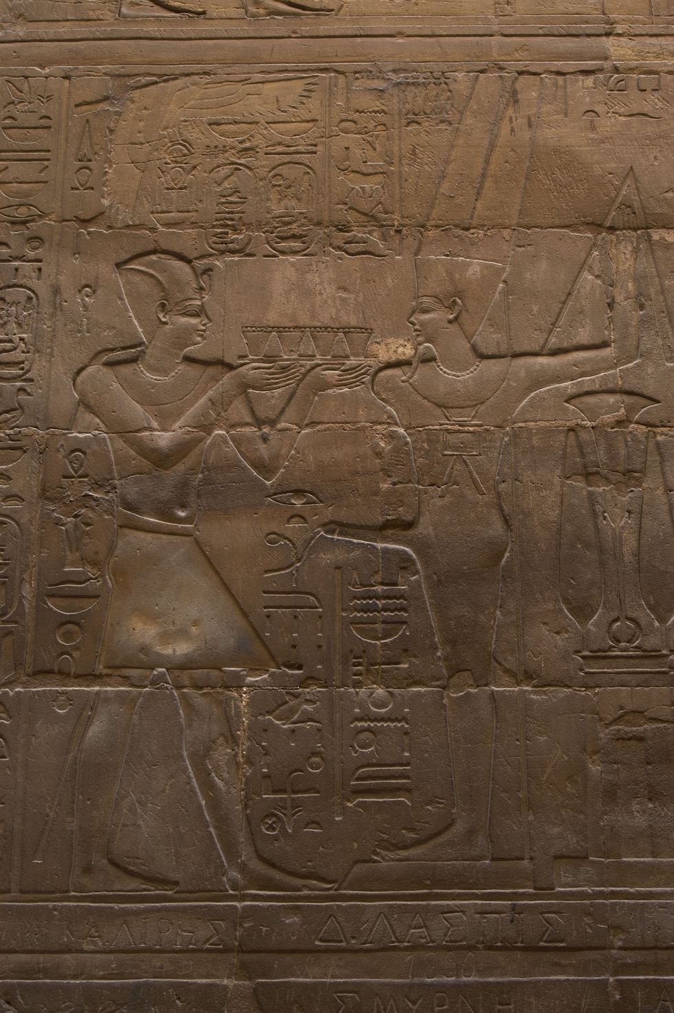 Photo of a relief depicting a pharaoh making offerings to the god MIN, god of fertility.