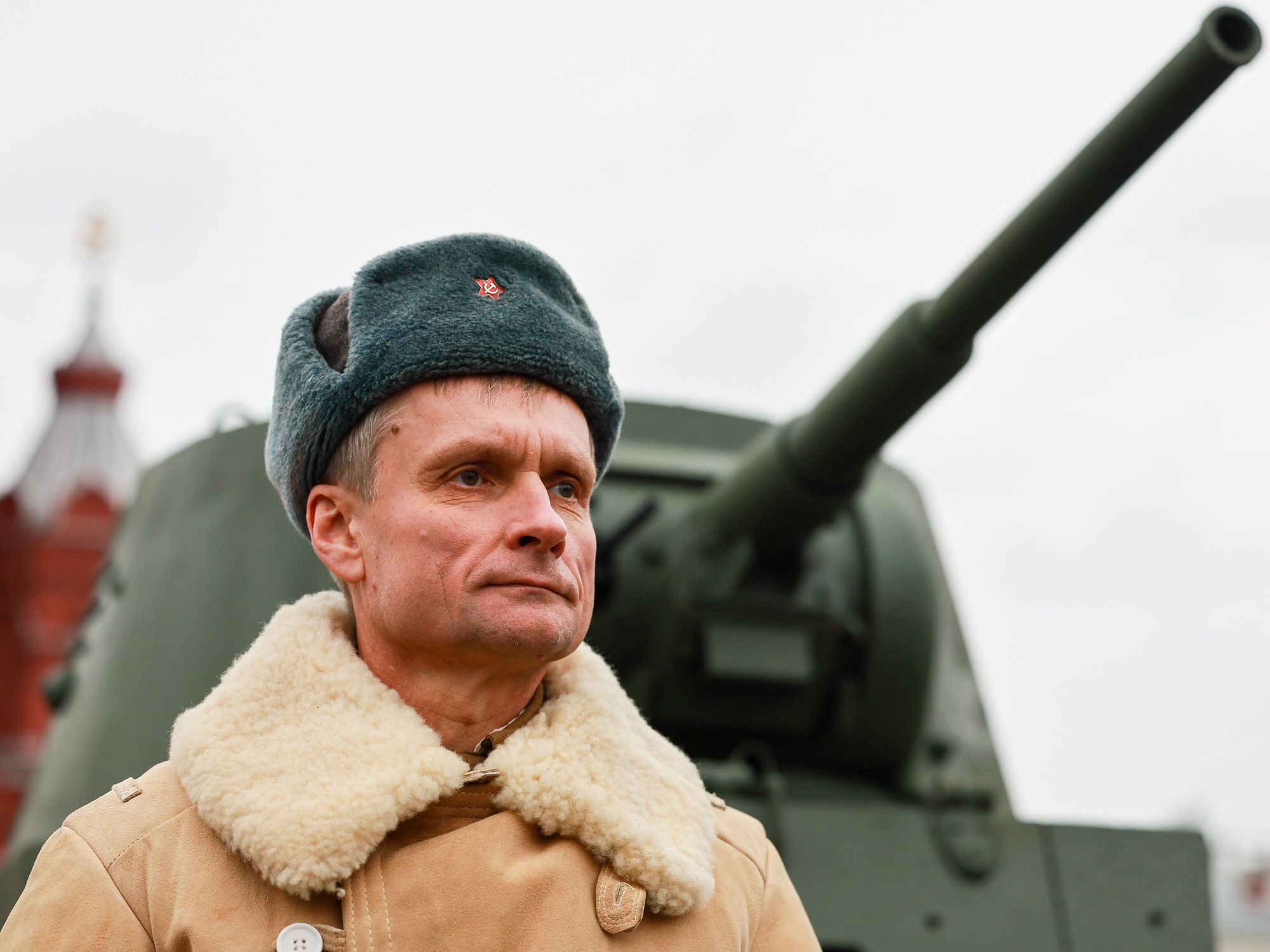 photo of a russian man in front of a tank