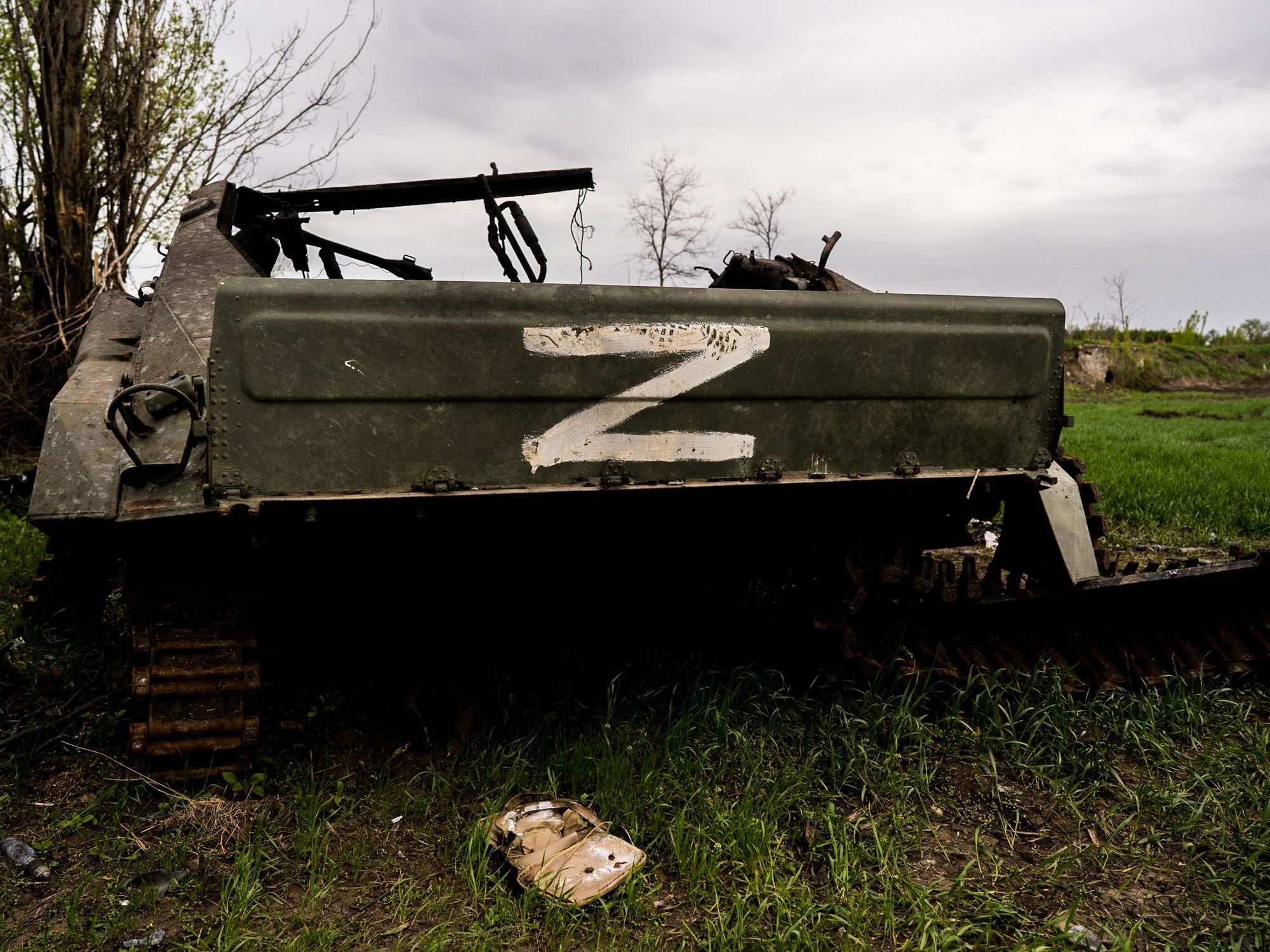 Photo of a Russian tank destroyed during street fighting in Mala Shestirnya in Ukraine, with a white letter "Z" painted on the side.