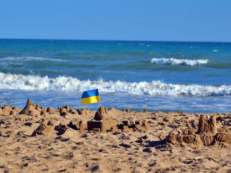 Photo of a sand castle with the Ukrainian flag on top