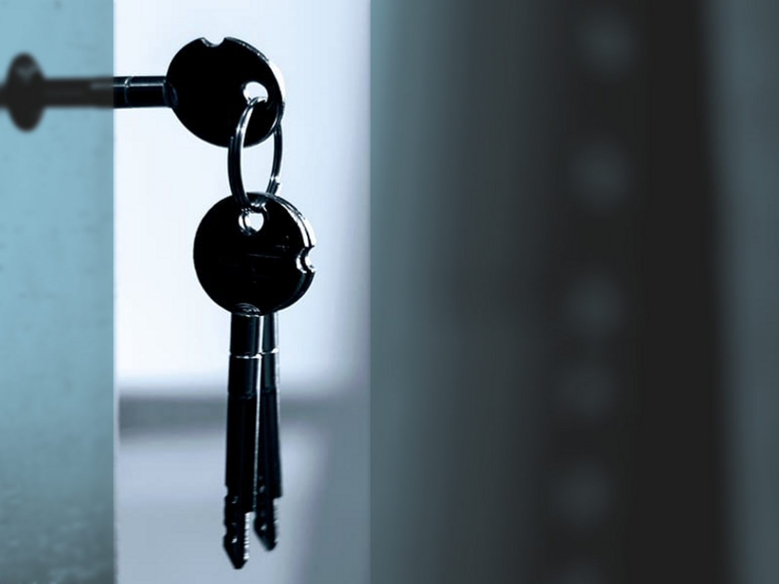 Photo of a set of keys dangling from a keyhole