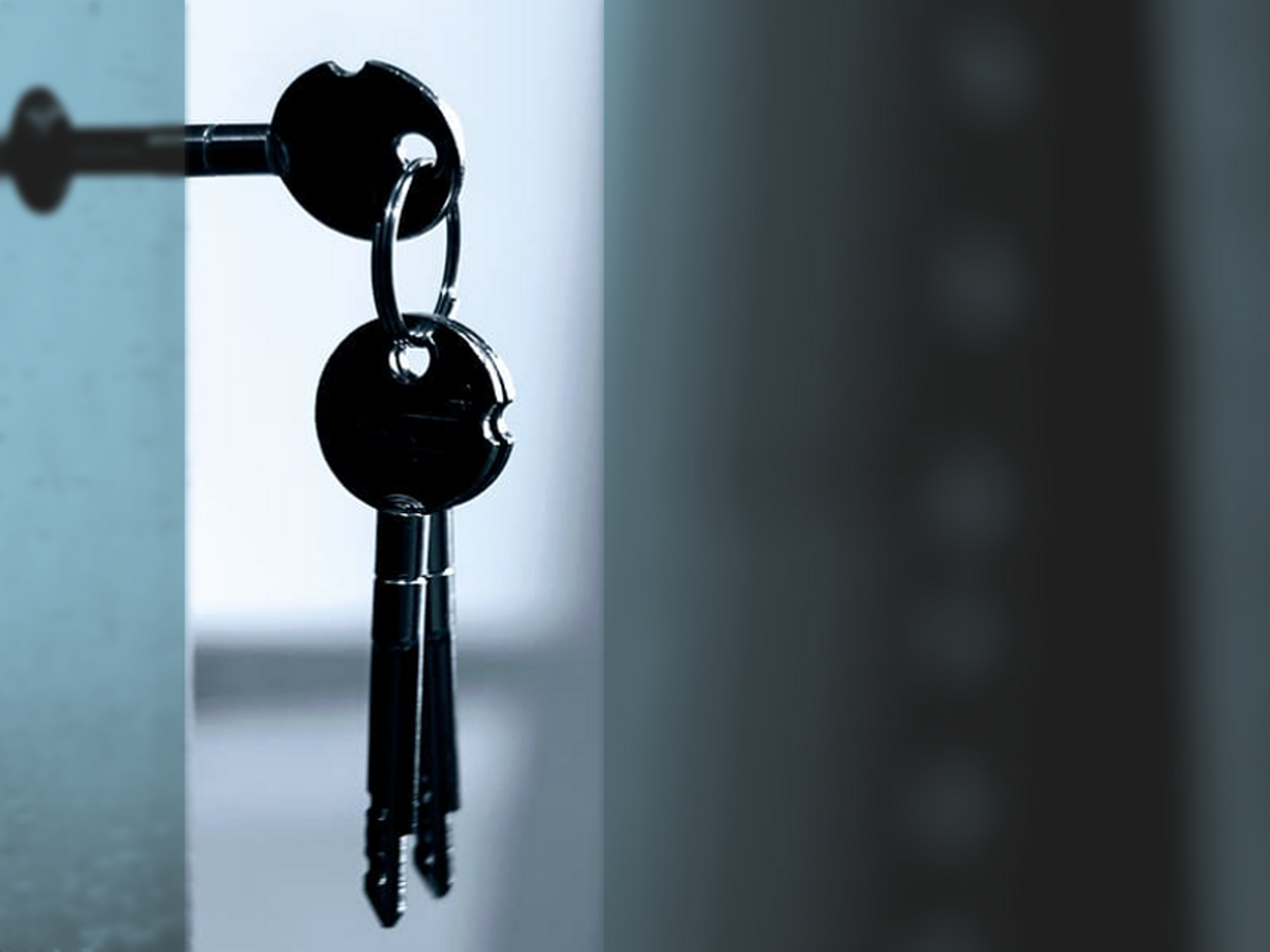 Photo of a set of keys dangling from a keyhole