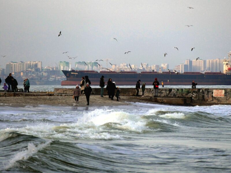 Photo of a ship arriving in Odessa, Ukraine, on February 26, with people on a jetty.