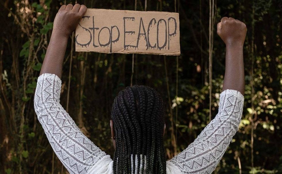 Photo of a sign that reads "stop EACOP"