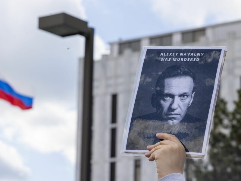 photo of a sign with a photo of Navalny