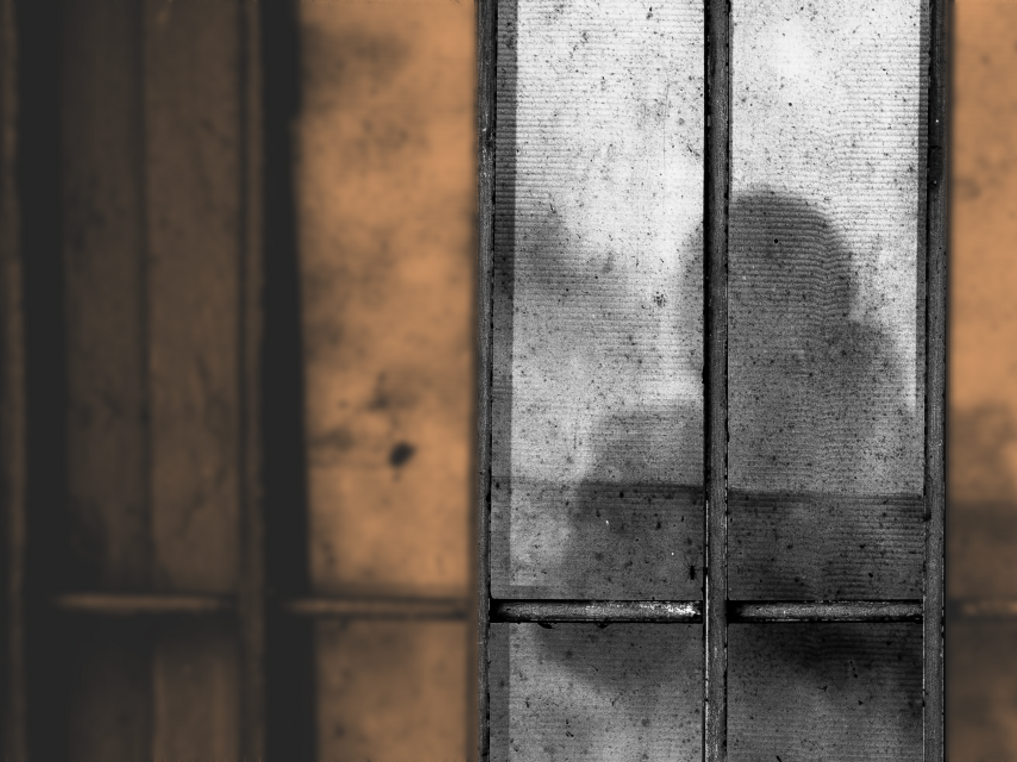 Photo of a silhouette behind prison bars