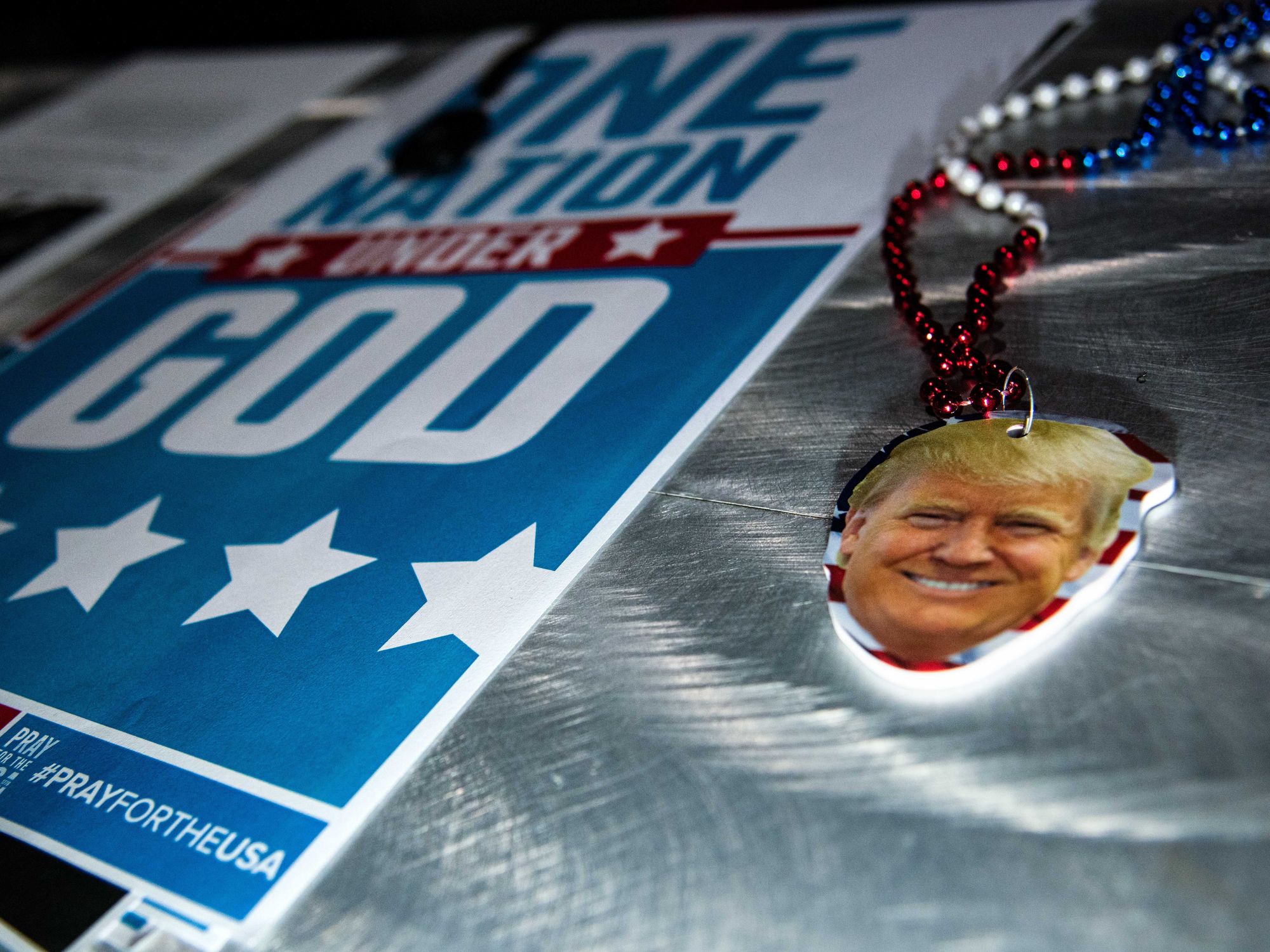 Photo of a small cutout face of Donald Trump next to a "One Nation Under God" leaflet