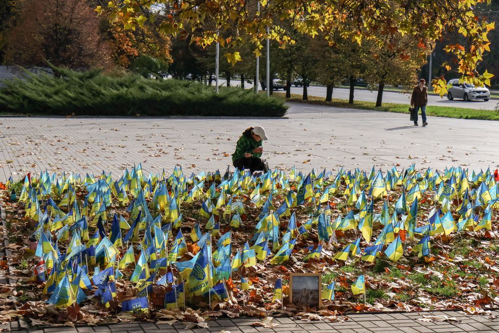 Photo of a small Ukrainian flags gathered at a memorial site in Zaporizhzhia, Ukraine dedicated to fallen soldiers
