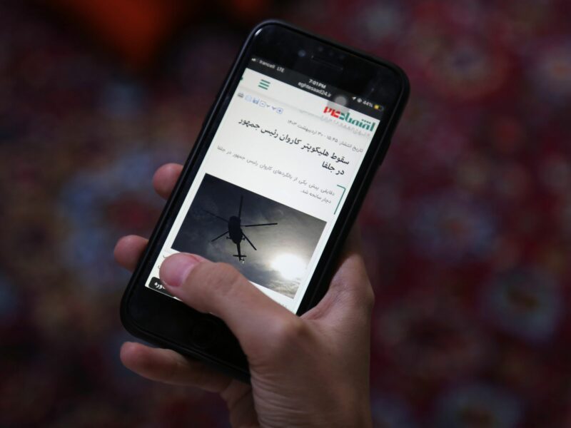 photo of a smartphone with a photo of a helicopter
