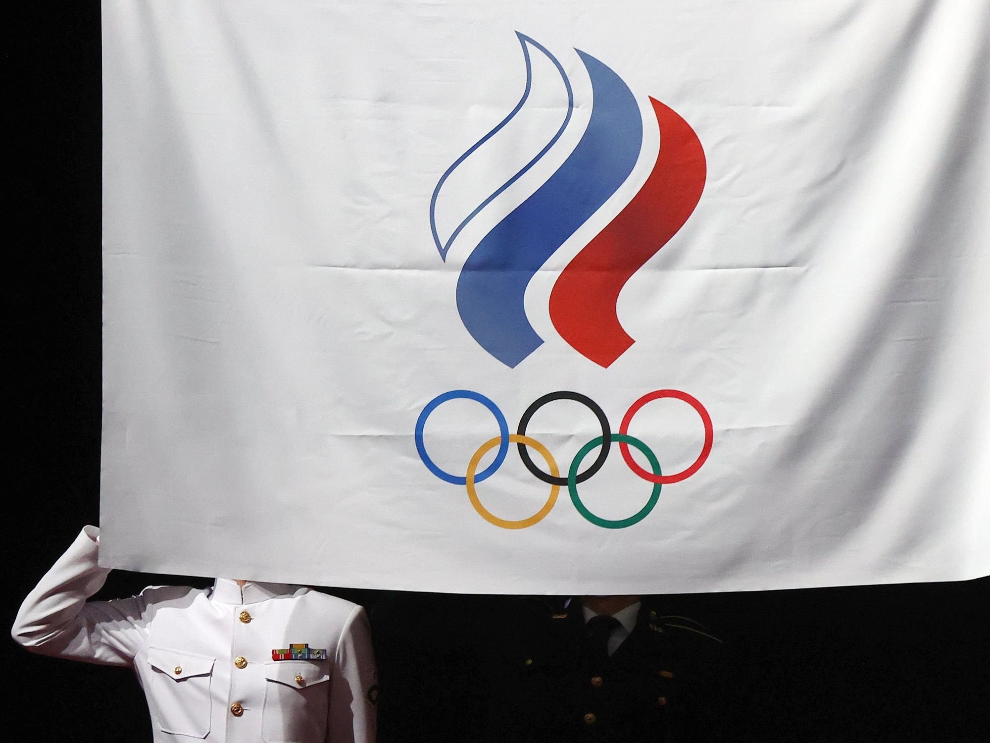 photo of a soldier being blocked by the Russian olympic committee flag