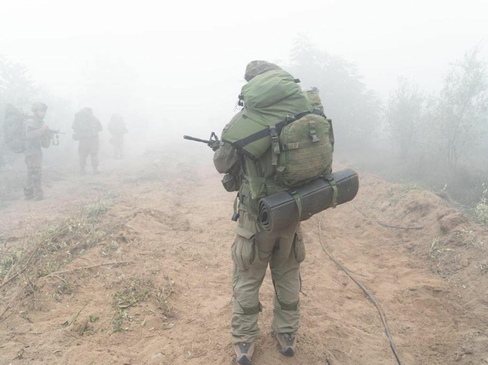 photo of a soldier from behind in fog