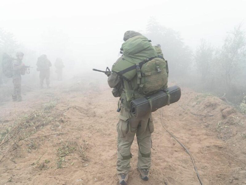 photo of a soldier from behind in fog