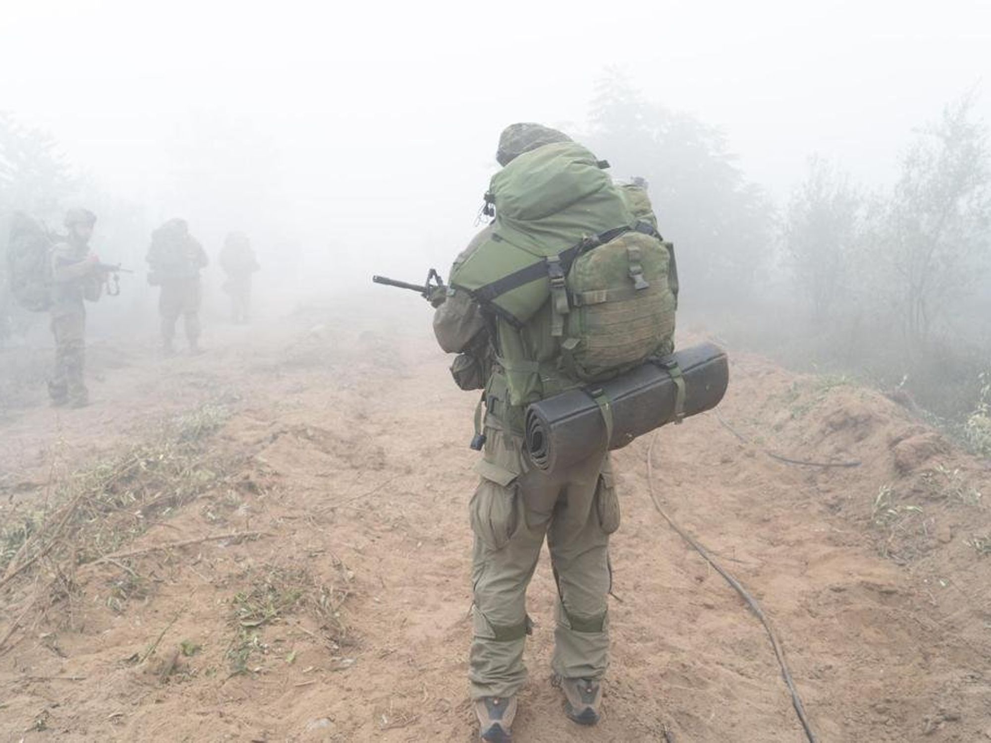photo of a soldier from behind in fog