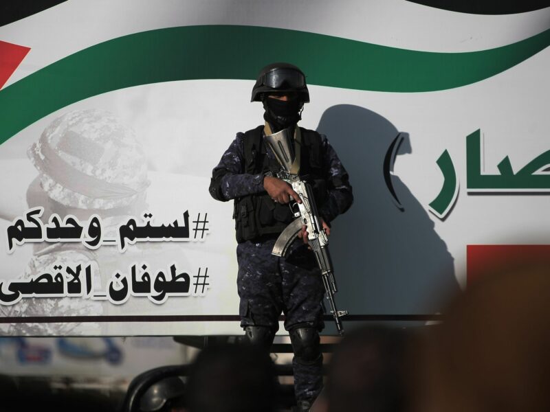 photo of a soldier with face covered standing guard