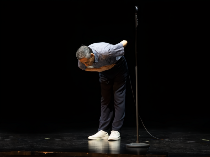 Photo of a Stand-up comedian taking a bow onstage after performing at Beijing's ​Laughing Fruit Factory