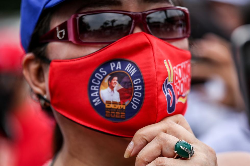 Photo of a supporter wearing a face mask adorned with Ferdinand ''Bongbong'' Marcos Jr. slogan