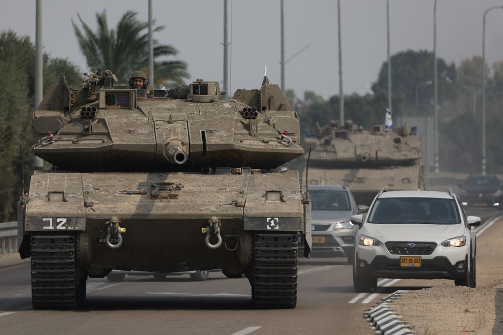 photo of a tank on a highway, with a car moving out of the way