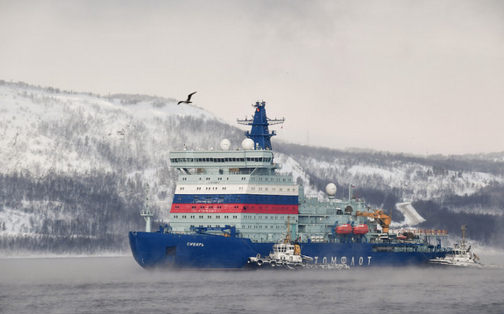 Photo of a tanker in Murmansk, Russia, with snowy mountains behind it