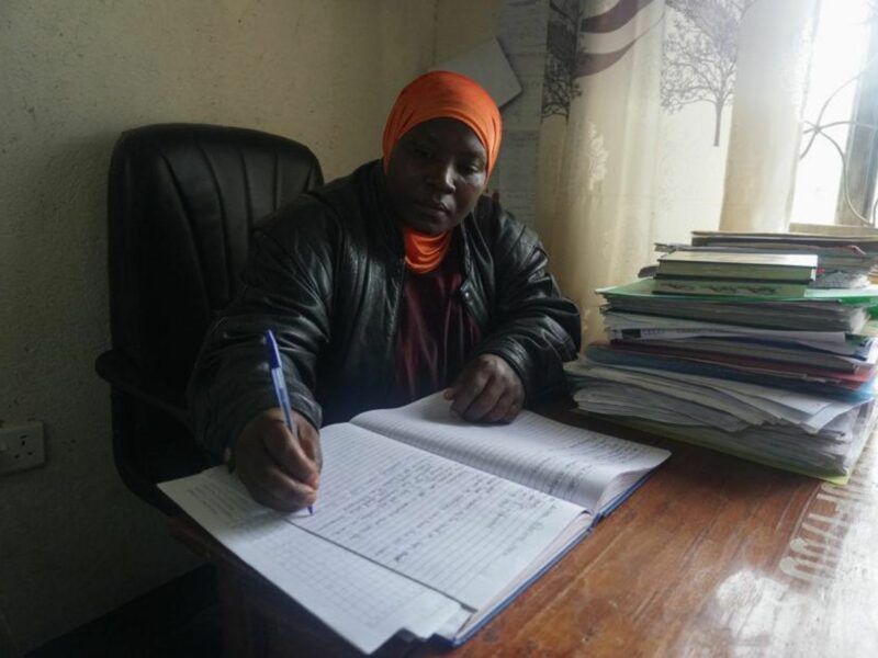 photo of a teacher writing in a notebook