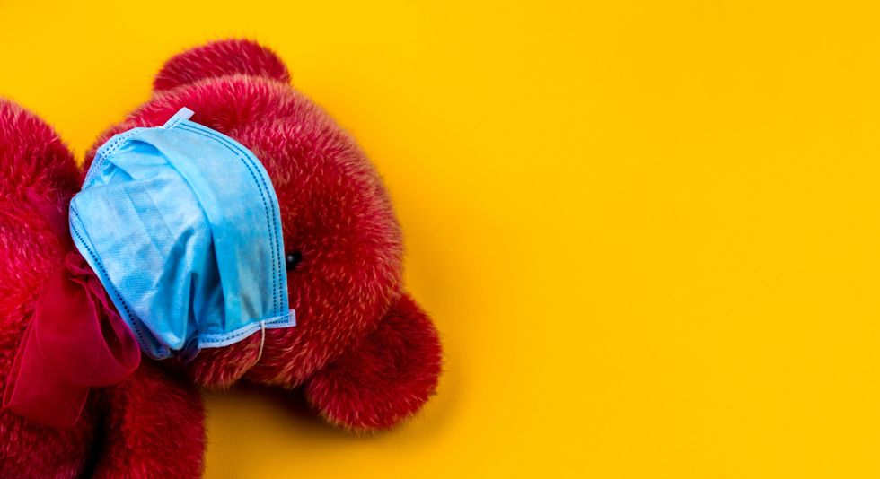 photo of a teddy bear with a mask