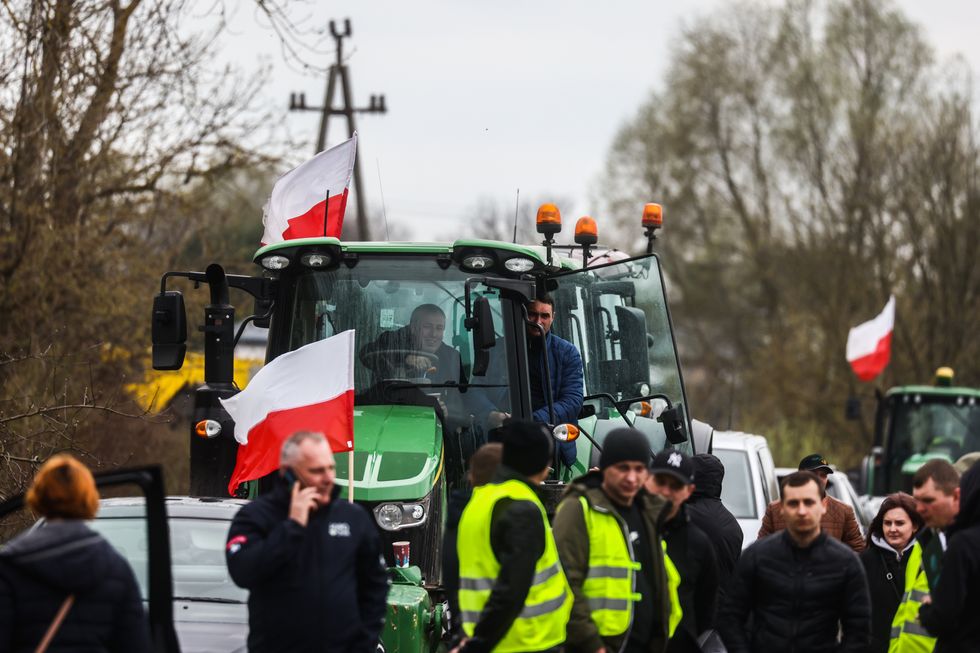 photo of a tractor and farmers at a protest