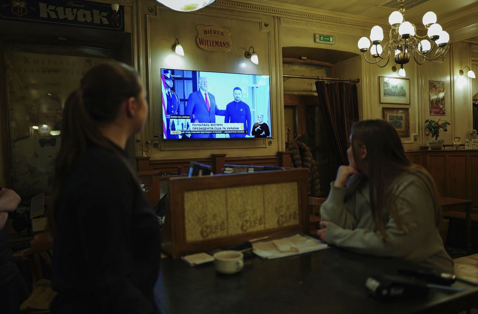 Photo of a TV screen in Kyiv showing the meeting between U.S. President Donald Trump and Ukrainian President Volodymyr Zelensky.