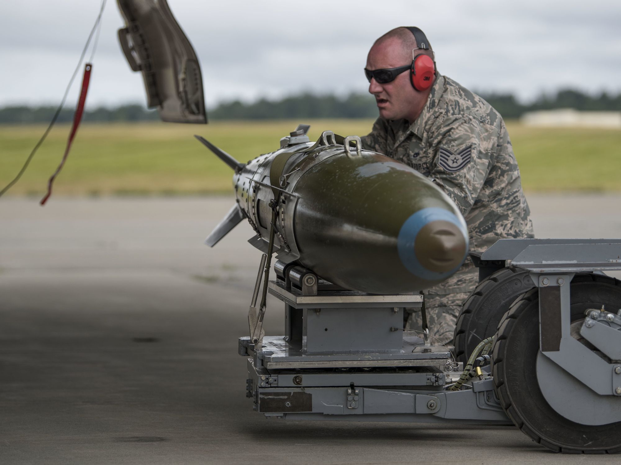 Photo of a U.S. Air Force soldier practicing weapons loading on the tarmac at a U.S. base in Alaska.