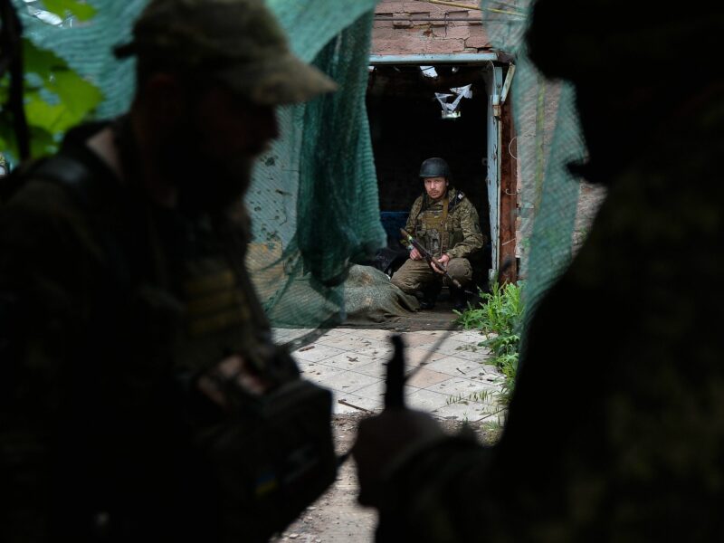 Photo of a Ukrainian soldier crouching as he hides from Russian drones near Kyiv.