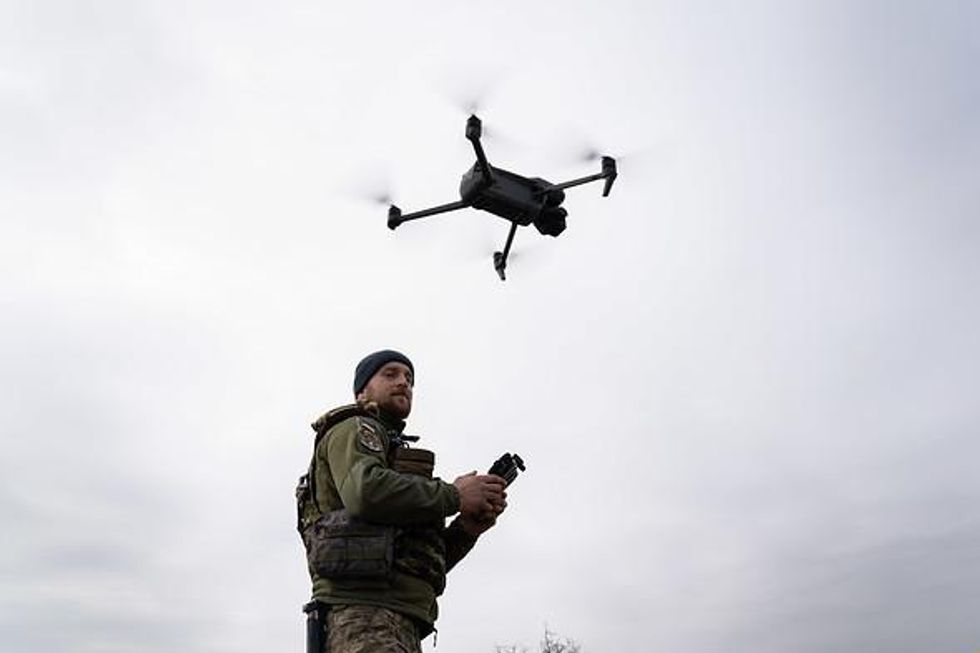 Photo of a Ukrainian soldier flying a military drone near Mykolaiv