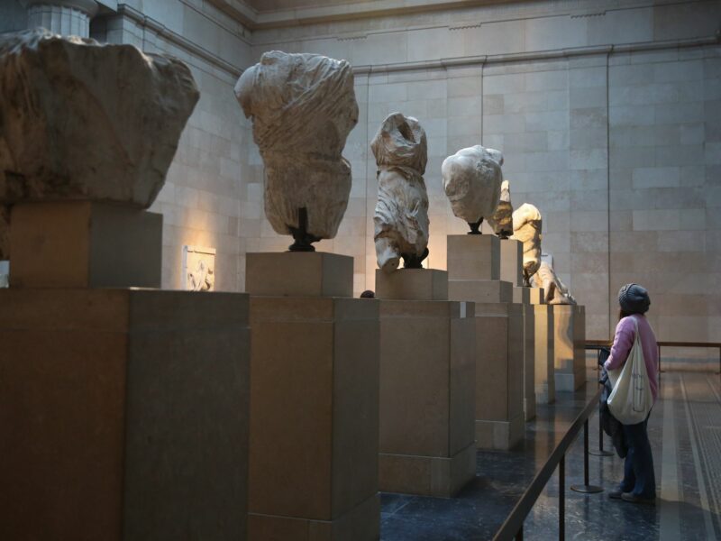 Photo of a visitor looking at the Elgin marbles also known as the Parthenon marbles, at the British Museum