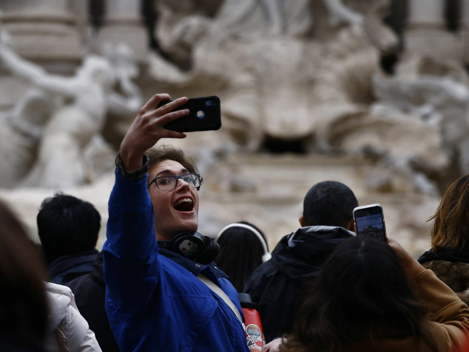 photo of A visitor takes a selfie after the reopening of the Trevi Fountain in Rome