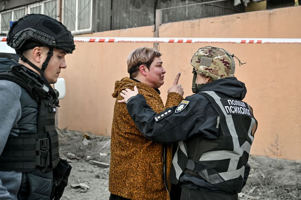 photo of a woman after a bombing being talked to by authorities