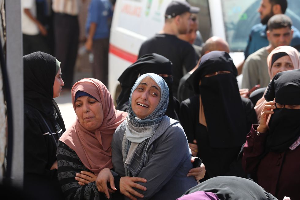 photo of a woman crying and another comforting her