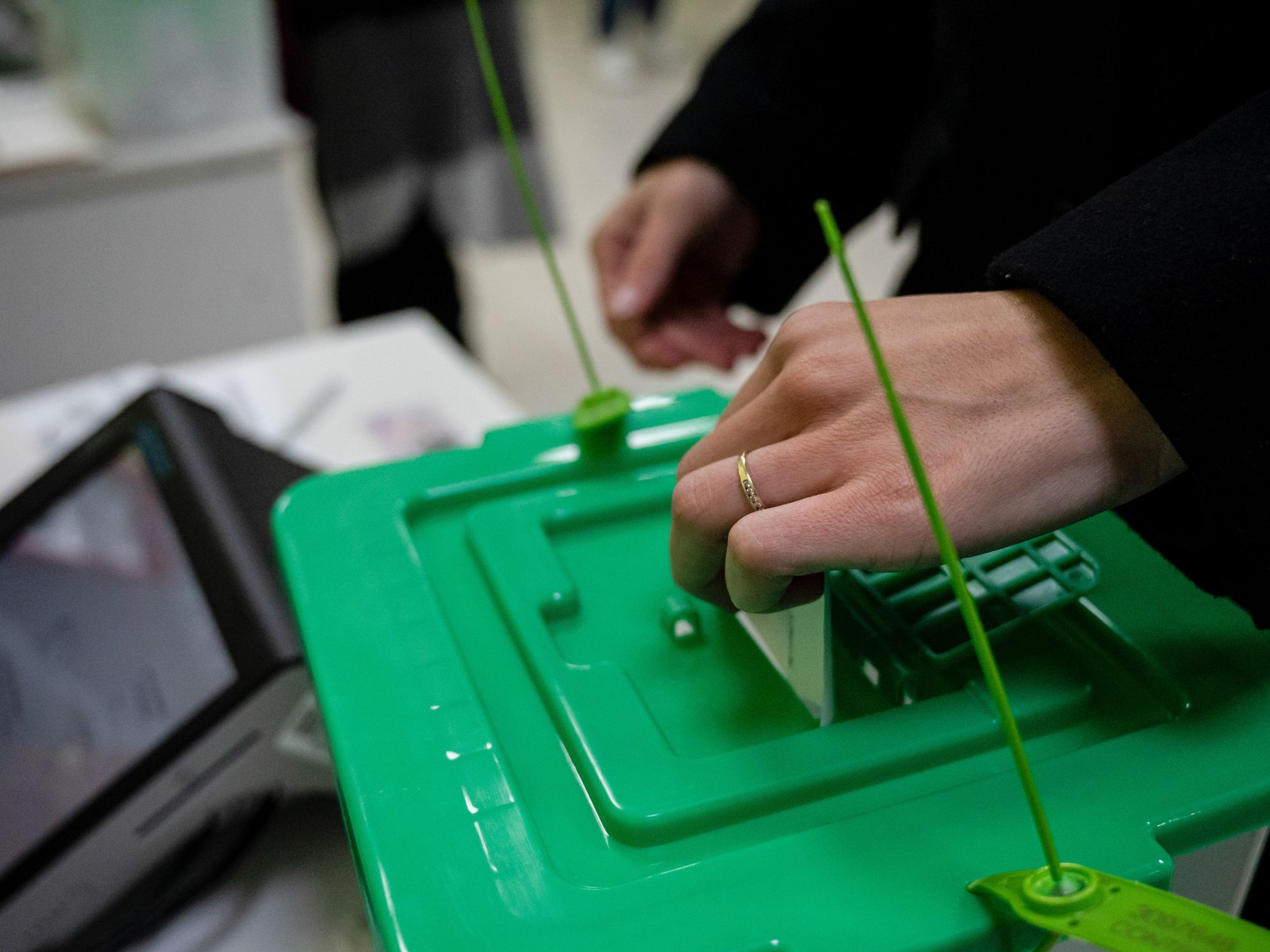 Photo of a woman depositing a ballot in a voting box in Tbilisi, Georgia, on Oct; 26