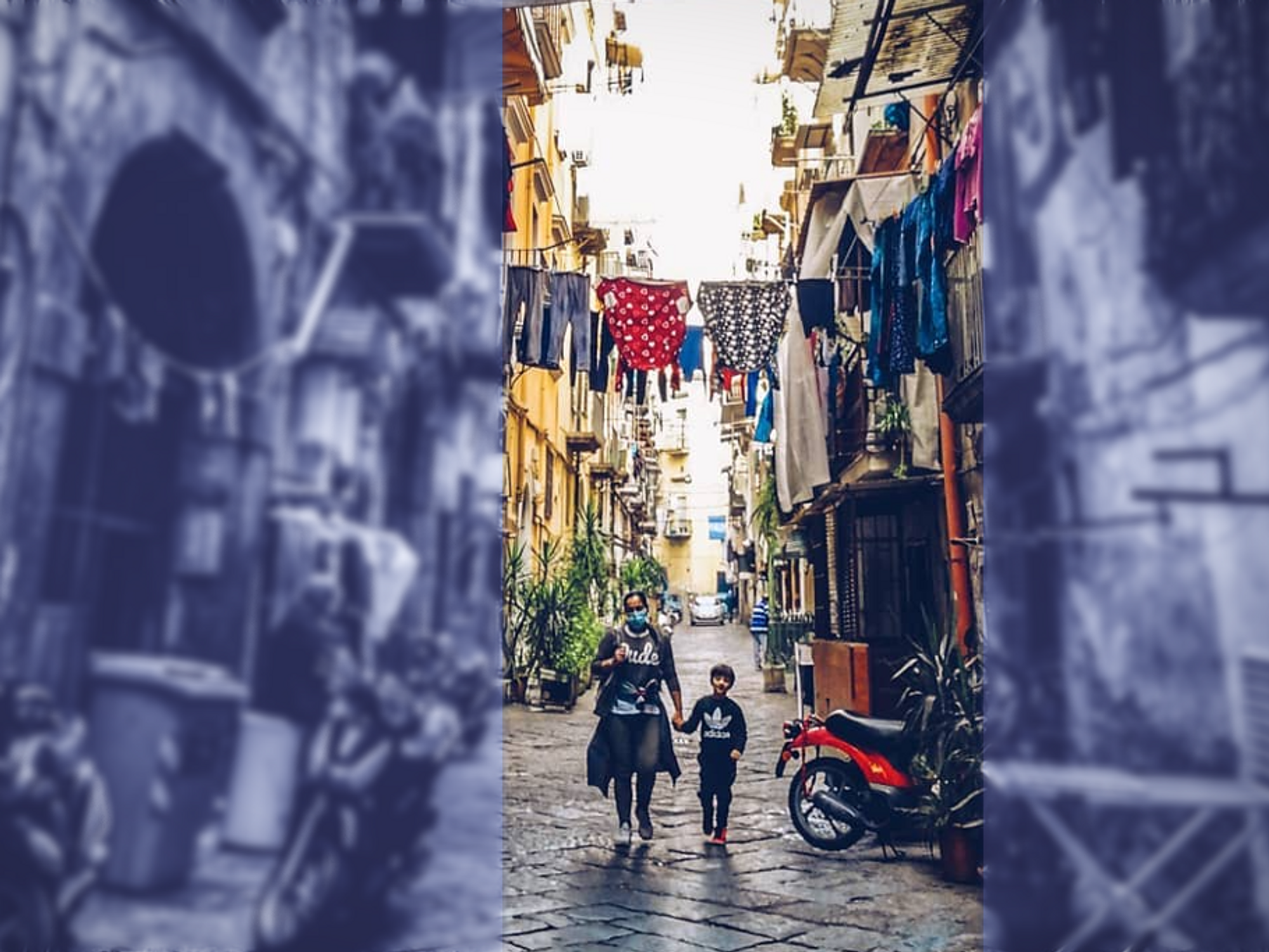 Photo of a woman holding a child's hand in the Sanità neighborhood of Naples