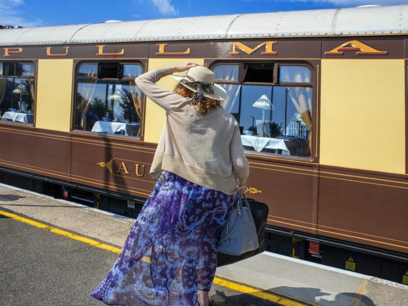 Photo of a woman in front of the Belmond British Pullman luxury train