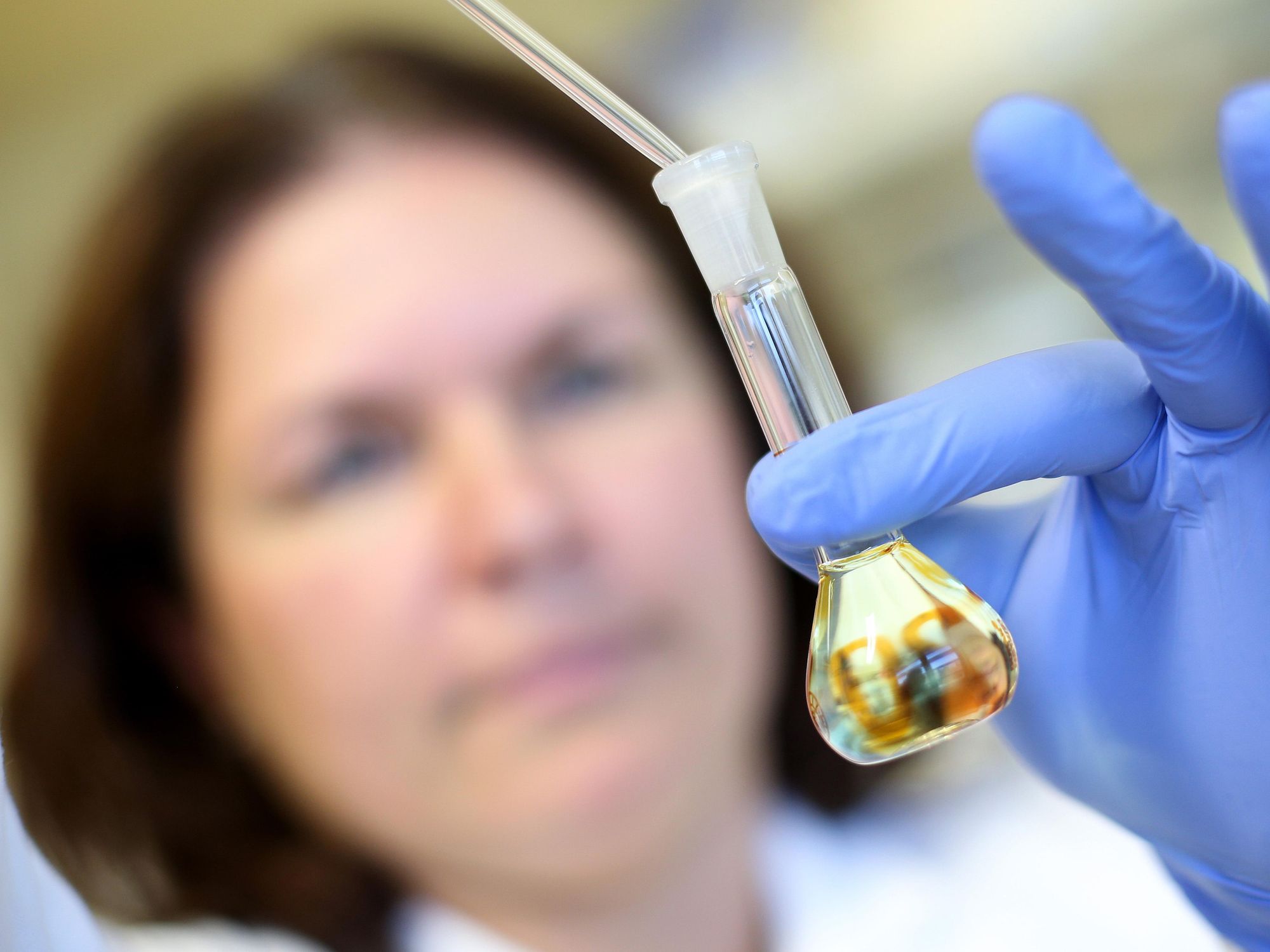 photo of a woman injecting liquid into a test tube