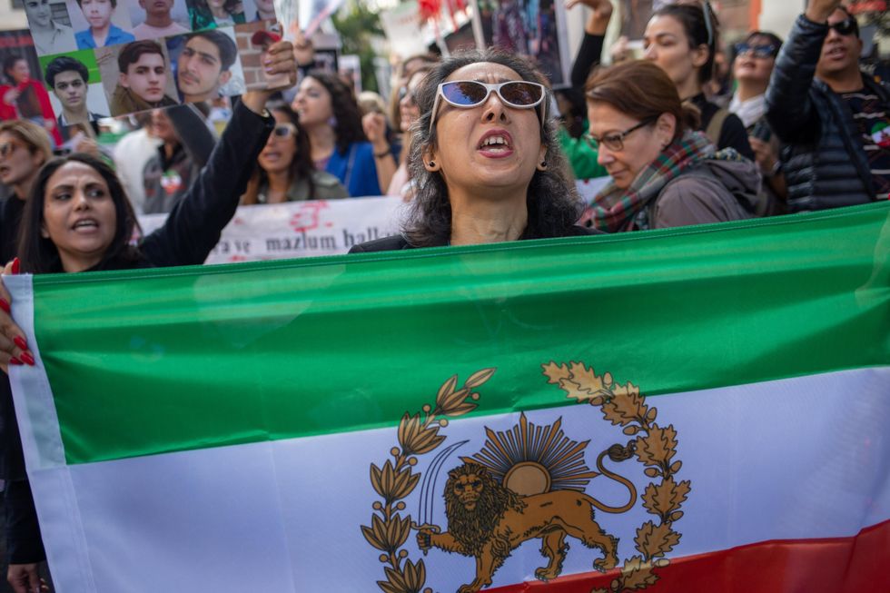 Photo of a woman protesting against the Iranian regime