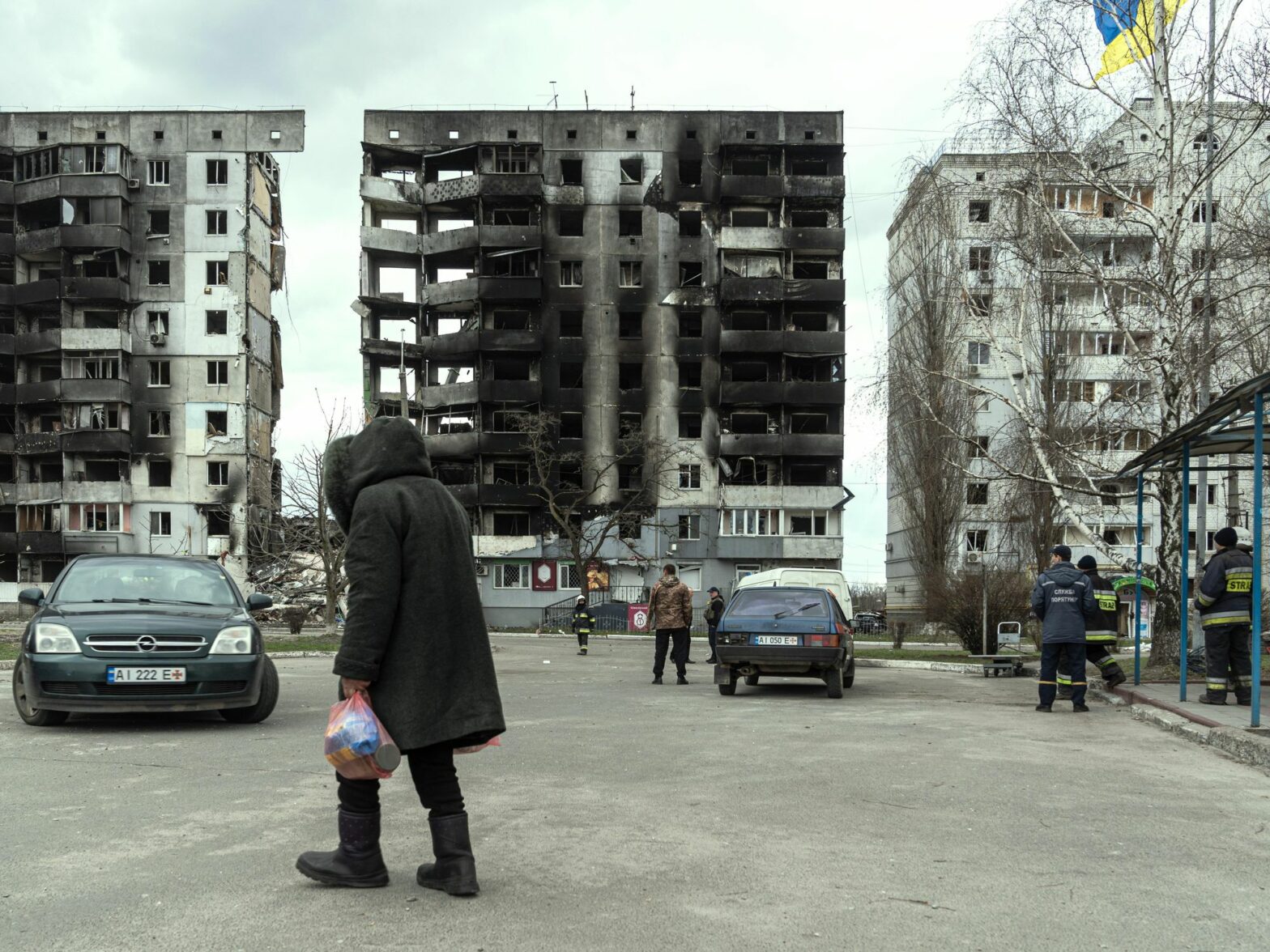 Photo of a woman walking past destroyed buildings in Borodyanka near Kyiv