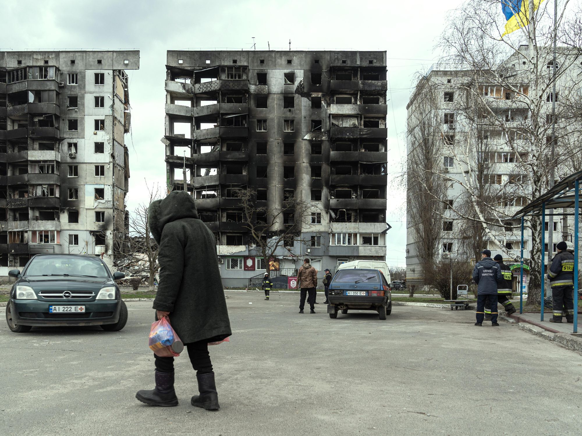 Photo of a woman walking past destroyed buildings in Borodyanka near Kyiv
