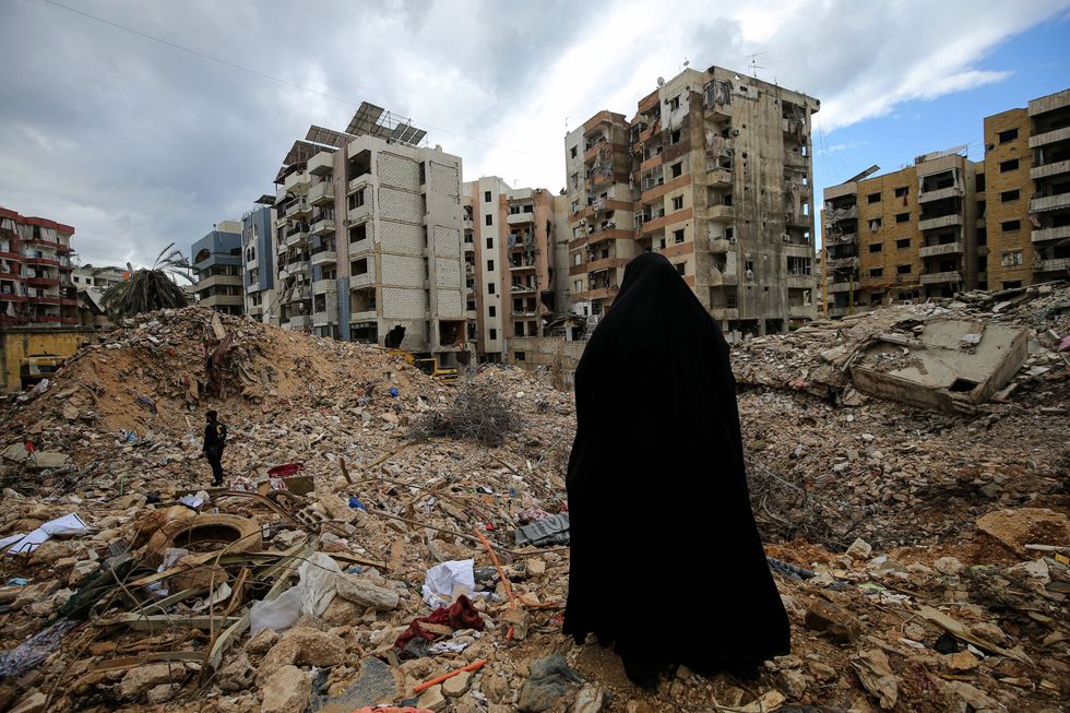 Photo of a woman walking through the rubble in Beirut on Feb. 21