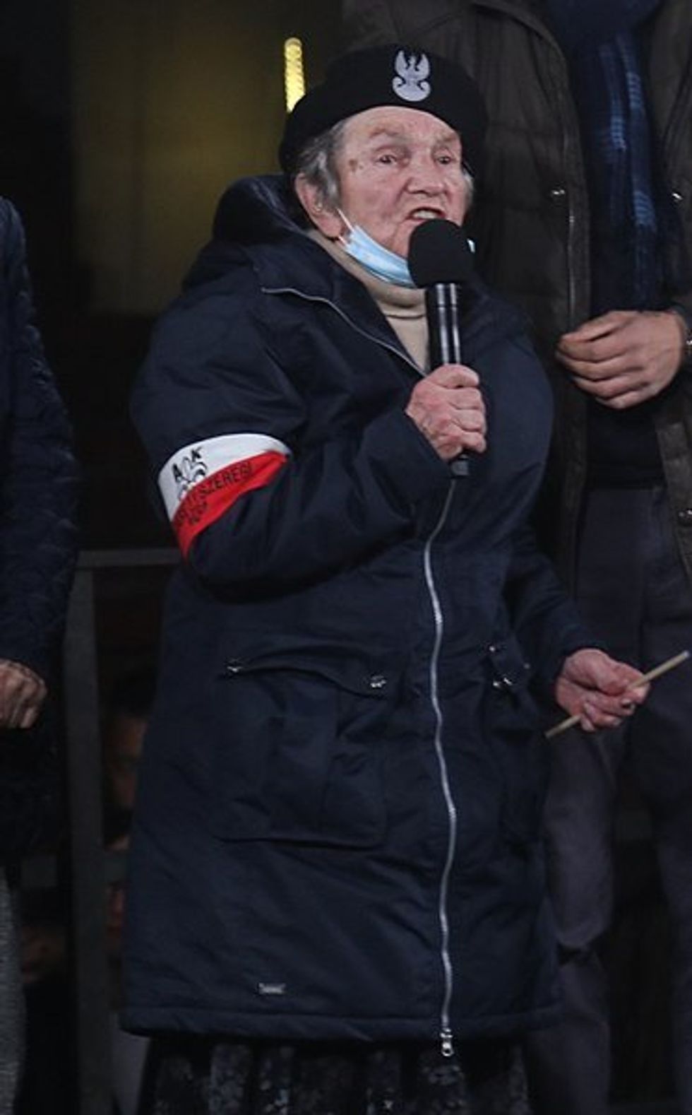 Photo of a woman (Wanda Traczyk-Stawska) standing and talking in a mic.
