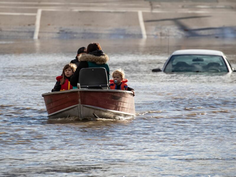 Photo of a woman with her children stranded in high water in Abbotsford, British Columbia following massive floods triggered by torrential rains in western Canada.