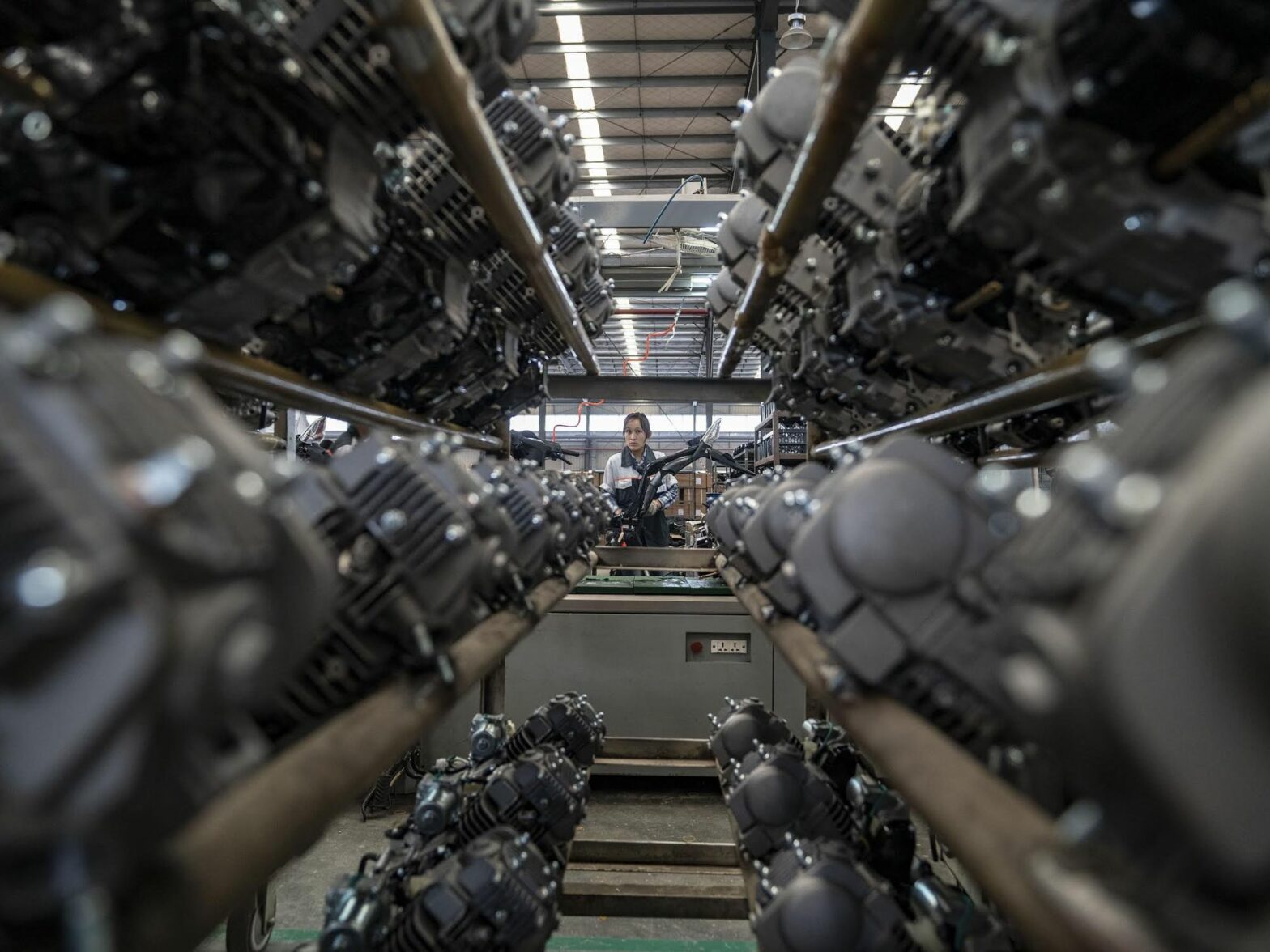 Photo of a woman working at a motorbike factory in China's Yunnan Province.